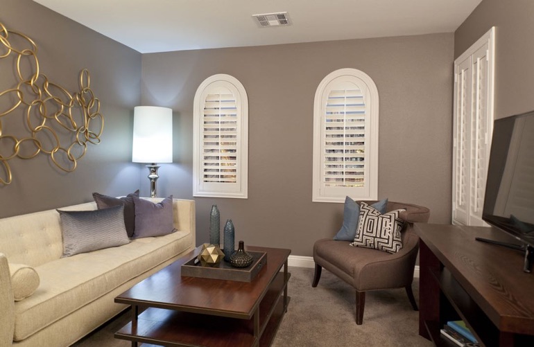 White shutters on arched windows in family room